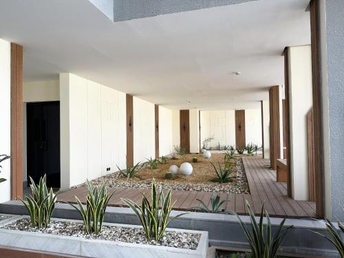 a courtyard with plants in a building at Mabaat-Executive 3BR-Al Narjis - 619 in Riyadh