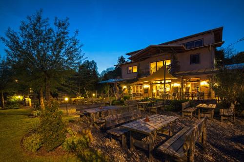 a building with a table and benches in front of it at Im-Jaich Wasserferienwelt in Lauterbach
