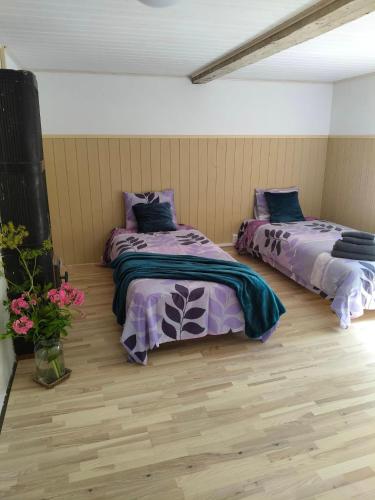 two beds sitting next to each other in a room at Parkal Apartments in Paide