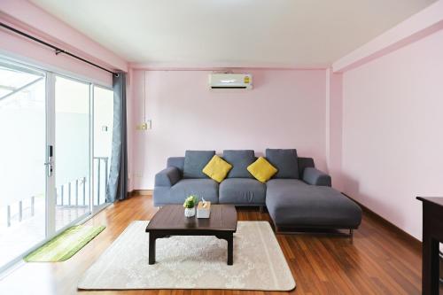 a living room with a couch and a table at The Cozy house near CMU in Chiang Mai