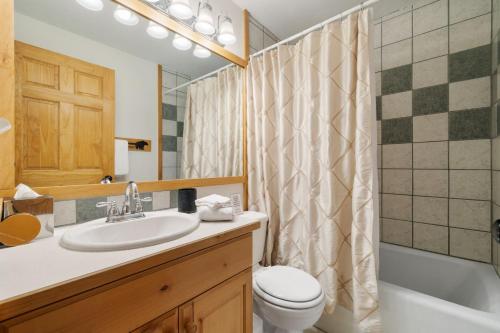a bathroom with a sink and a toilet and a shower at RMR: Three Bear Tracks Home in Teton Village in Teton Village