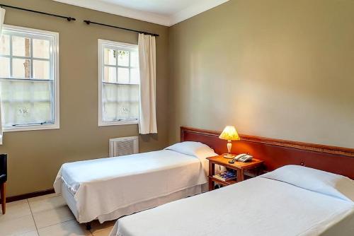 
Cama ou camas em um quarto em Vila Real Hotel
