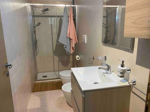 a bathroom with a toilet and a sink and a shower at Modern apartment - Salento Guest House in Monteroni di Lecce