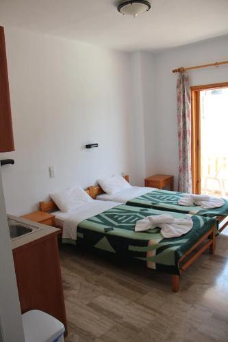 Postel nebo postele na pokoji v ubytování Hotel Alkyon