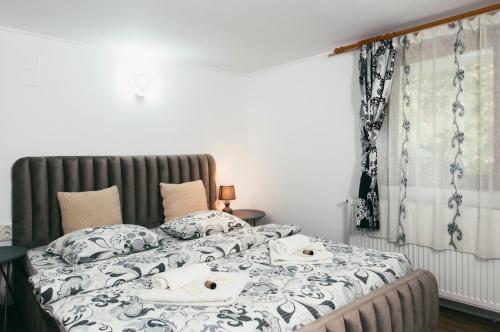 a bedroom with two beds with towels on them at CasaMaria in Slănic-Moldova