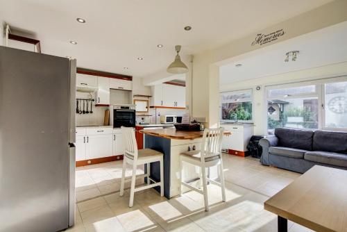 a kitchen and living room with a table and chairs at Spacious Tilbury Home - Perfect for Contractors, Families, Groups in East Tilbury