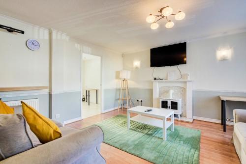 a living room with a couch and a fireplace at Spacious Tilbury Home - Perfect for Contractors, Families, Groups in East Tilbury
