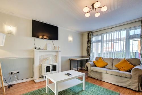 a living room with a couch and a fireplace at Spacious Tilbury Home - Perfect for Contractors, Families, Groups in East Tilbury