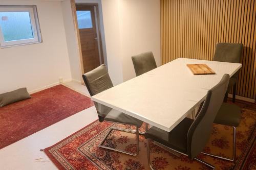 a meeting room with a white table and chairs at Cozy private house with free parking in Kongsvinger