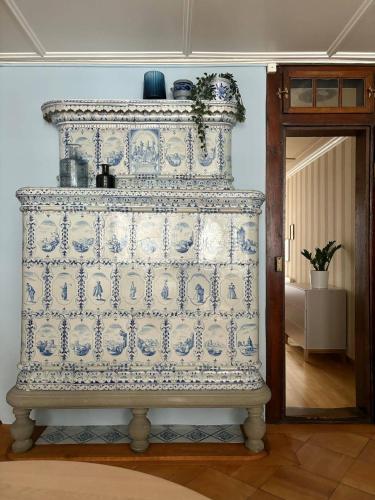 a blue and white patterned dresser in a room at Bright & Stylish-Heart of Old City-Experienced Hosts in Bern