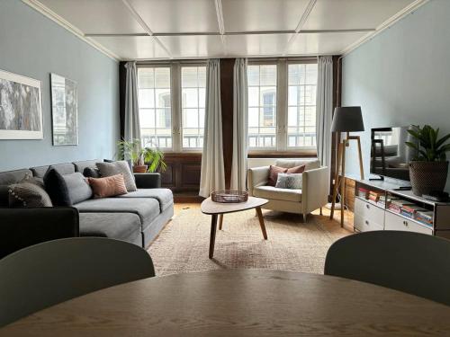 a living room with a couch and a table at Steps To Best Bern Sites And Lots Of Space Too! in Bern