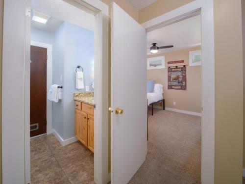 a bathroom with a vanity and a sink in a room at RMR: Four Seasons I 2 Condo in Teton Village in Teton Village