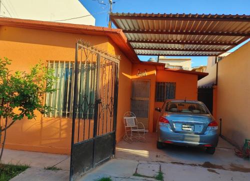 a small car parked in front of a house at Connected House in Torreón in Torreón