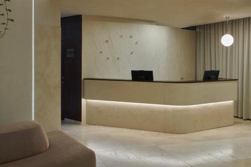 a lobby with a reception desk with avertisement at Mana Suites & Sea in Palanga