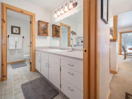 a bathroom with a sink and a toilet and a mirror at RMR: Cedars 1412 Condo in The AspensWilson WY in Wilson