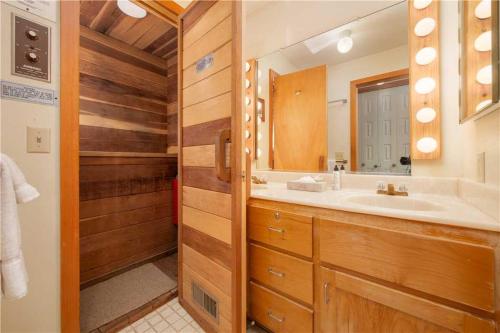 a bathroom with a sink and a mirror at RMR: Stock House in Teton Village in Teton Village