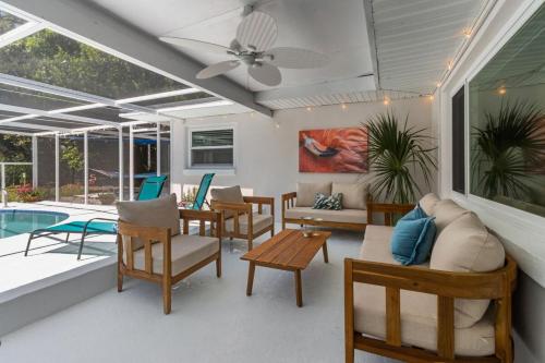 un patio amueblado y una piscina en Madeira Beach Pool Home with Guest House, en San Petersburgo