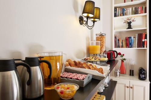 - un comptoir de cuisine avec un mixeur et une boîte de pâtisseries dans l'établissement Hotel Le Twelve, à Paris