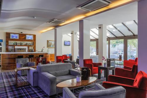 a lobby with couches and chairs and a bar at Gonluferah Thermal Hotel in Bursa