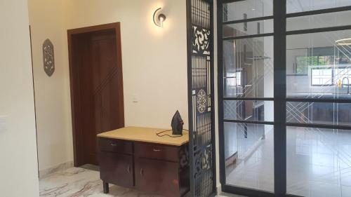 a room with a wooden desk next to a door at 3 bedroom modern house in Lahore