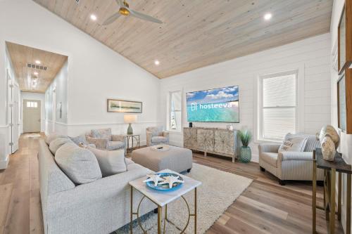 a living room with a couch and a tv at Luxury 4BR, Across street from beach, Sleeps 10! in Gulf Shores