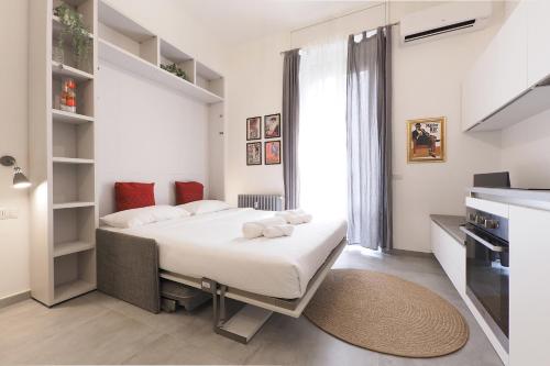 a bedroom with a bed and a large window at PrimoPiano - Sempione in Milan