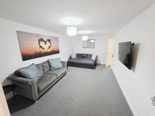 a living room with a couch and a bed at The Willows Haven - Thurnscoe, Rotherham in Thurnscoe