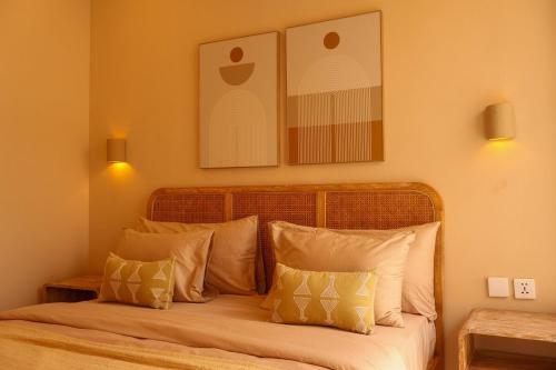 a bedroom with a bed with white pillows at Pasir 4 - A stylish 2 bed villa in Bingin w pool in Bingin Beach