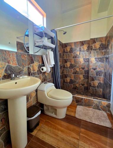 a bathroom with a toilet and a sink and a shower at Loft Casa Yucay in Yucay