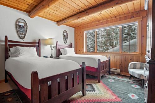 a bedroom with two beds and a window at RMR: Teton View Cabin Home in WilsonWY in Wilson