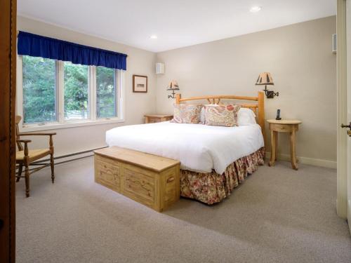 a bedroom with a large bed and a window at RMR: Snow Ridge 4 Condo in Teton Village in Teton Village