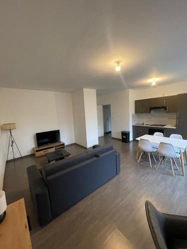 a living room with a couch and a table at Business Apparts Caudry in Caudry
