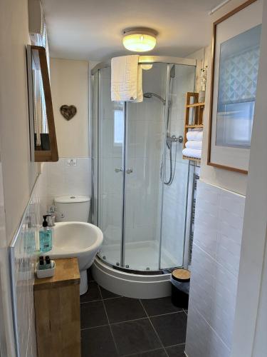 a bathroom with a shower and a sink at Historic Peel House Serviced Apartments in Burton upon Trent