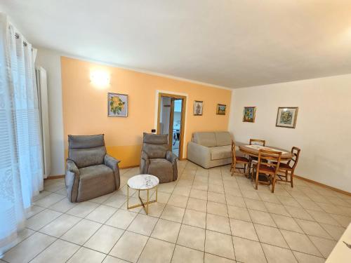 a living room with a table and chairs at Amanda 2 Apartments in Sarche di Calavino