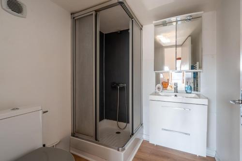 a bathroom with a glass shower and a sink at Le cocon - Appartement en hyper centre in Blois