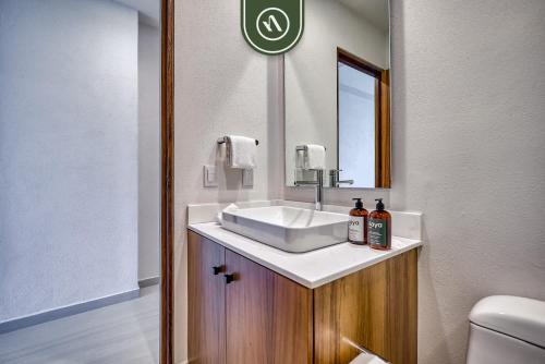 a bathroom with a sink and a mirror at New 1 BR Condo with Amazing Rooftop Pool - Jacuzzi in Bucerías
