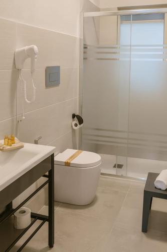 a bathroom with a shower and a toilet and a sink at Archè apartment AGRIGENTO in Agrigento