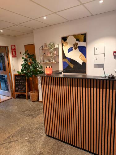 a lobby with a wooden bar in a room at Ewa & Maude Hotel in Gothenburg