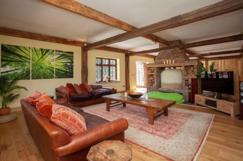 a living room with a couch and a table at Olli's Summer House - Natural Pool & Jacuzzi optional in Bristol