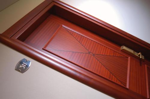a wooden door with a glass panel on it at Hotel Smeraldo in Lazise
