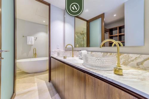 a bathroom with two sinks and a bath tub and a tubermott at New 3BR Condo - Oceanview Terrace - Private Beach in Higuera Blanca