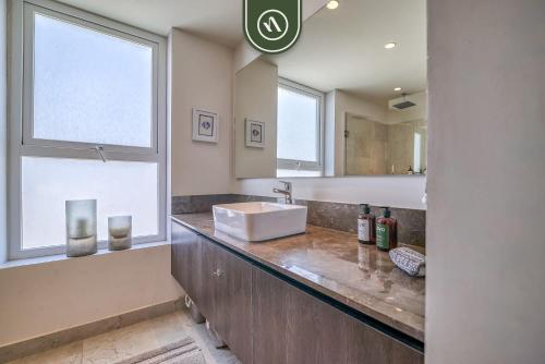 a bathroom with a sink and a mirror at Centric 2BR Condo- Balcony - Rooftop Pool in Bucerías