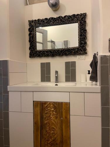 a bathroom with a sink and a mirror at Beautiful apartment & garden in Tel Aviv