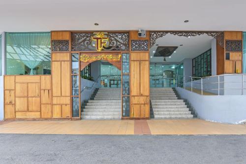 an entrance to a building with stairs and an open door at Sunday Near Jonker Street in Kampong Morten