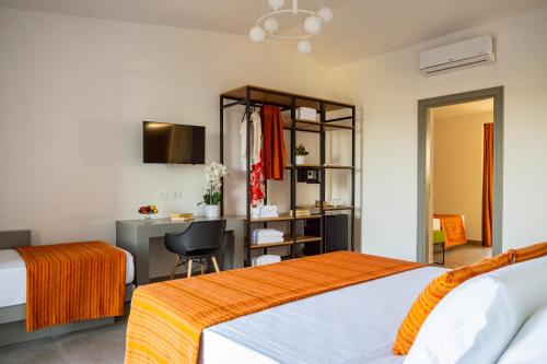 a hotel room with two beds and a desk at Policaretto Rooms by Calabria Stay in Torretta