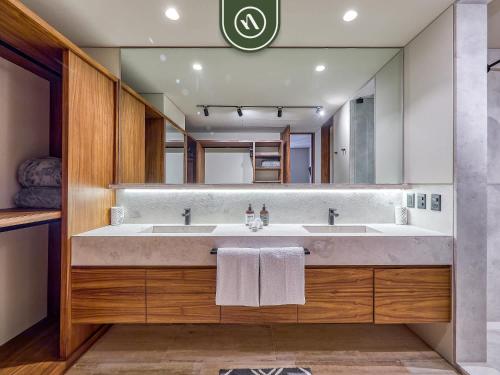 a bathroom with a large sink and a mirror at Luxury 4BR Oceanfront Condo - Private Beach - Pool in Cruz de Huanacaxtle