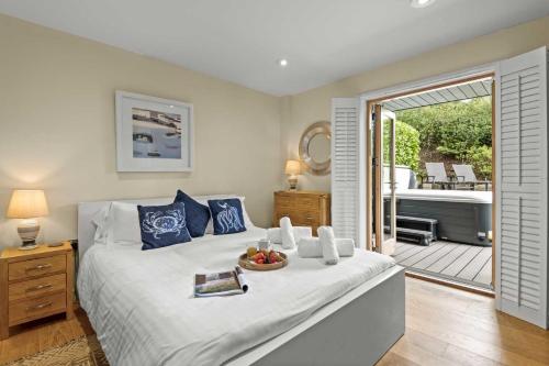 a bedroom with a bed with a bowl of fruit on it at House 31 in Looe
