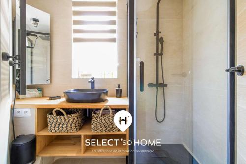 a bathroom with a sink and a shower at SELECT'soHOME - Duplex avec terrasse au cœur du village de Bormes-les-mimosas ! - IRUNDA in Bormes-les-Mimosas