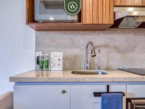 a kitchen counter with a sink and a microwave at Cozy Beachfront Studio - Beach Club - Pools in Nuevo Nayarit