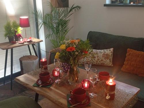 a living room with a table with candles and flowers at Heavens Embrace - ateliér pri Slovenskom raji in Smižany